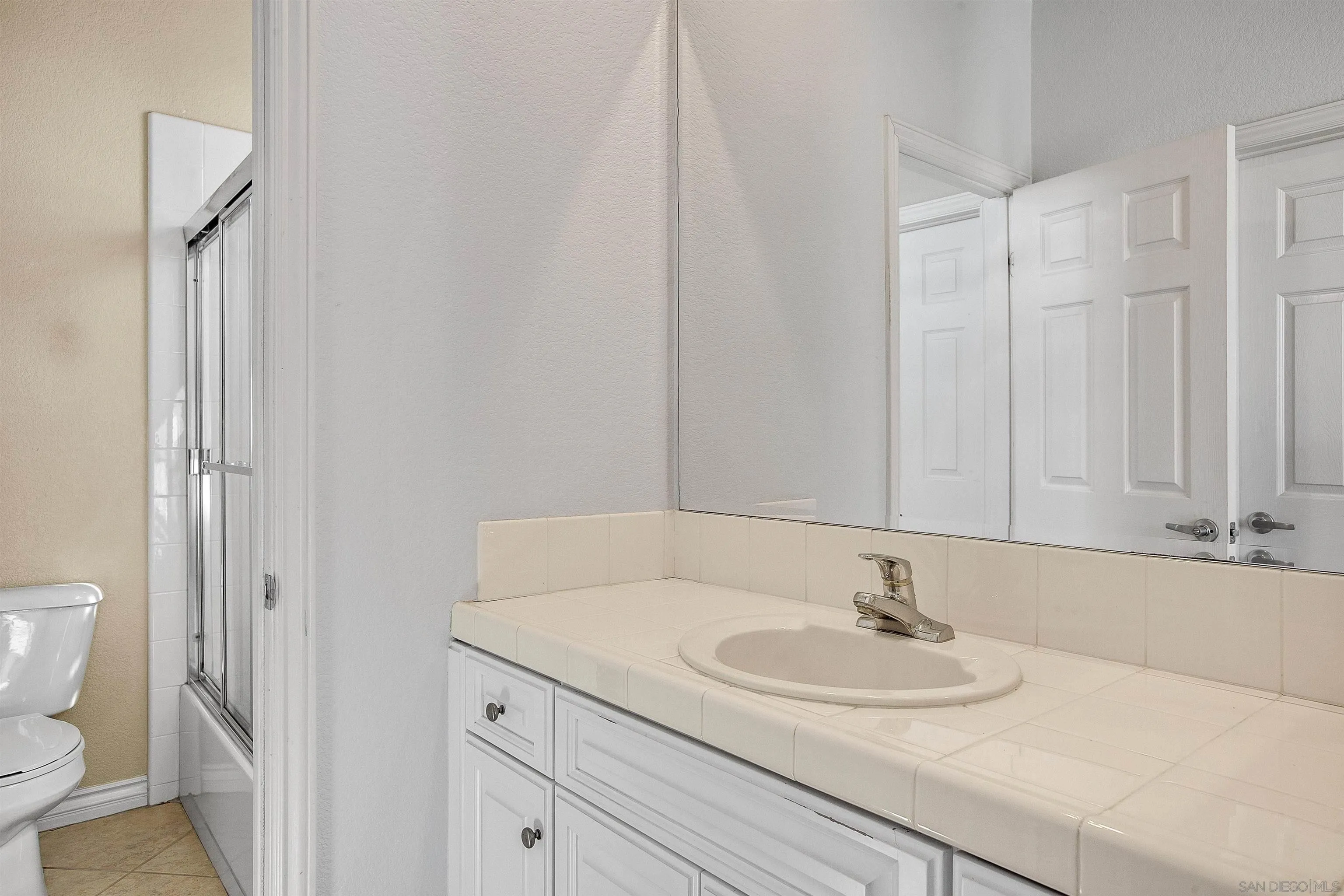 1460 Ravean Court Encinitas, CA 92024 - Photo 35 of 48 a bathroom with a sink and a toilet