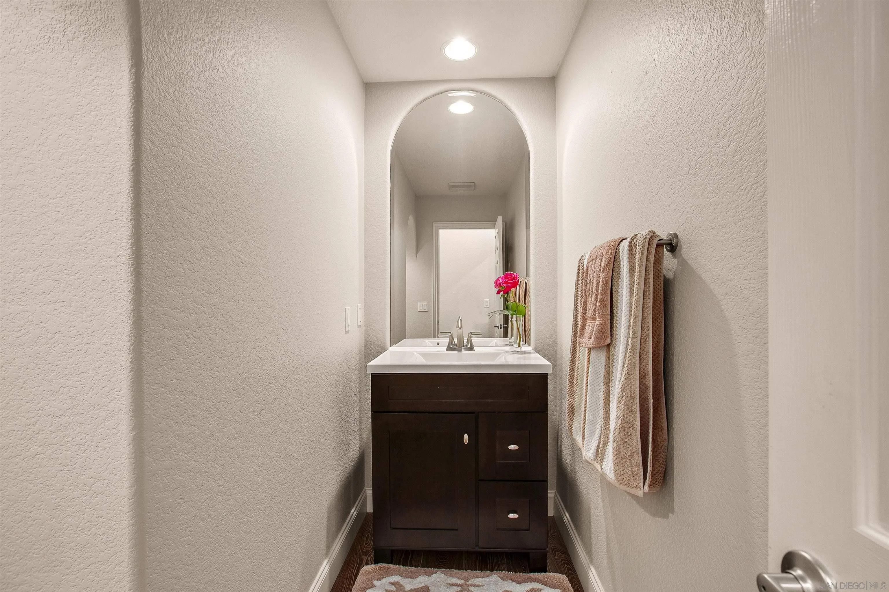 1460 Ravean Court Encinitas, CA 92024 - Photo 37 of 48 a bathroom with a sink and mirror