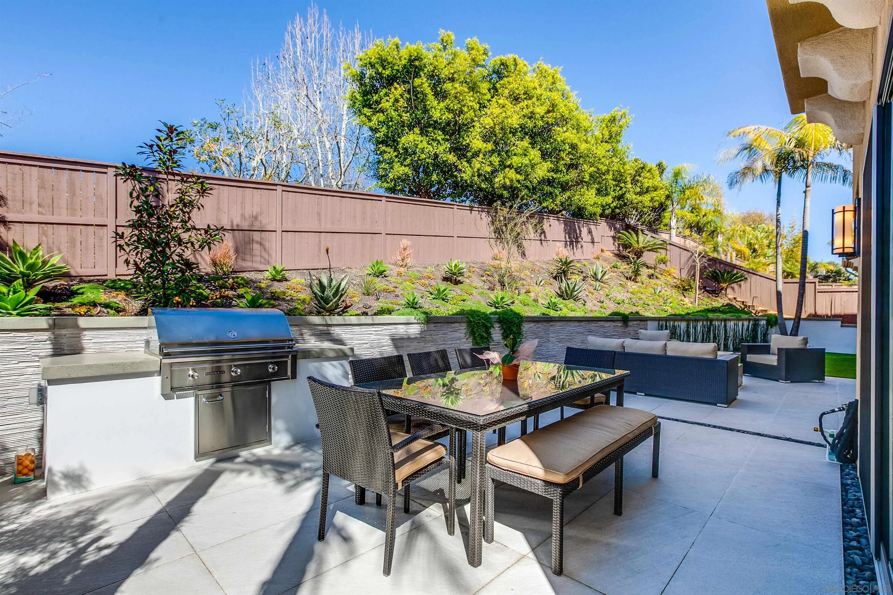 1460 Ravean Court Encinitas, CA 92024 - Photo 40 of 48 a view of a chairs and table in a backyard