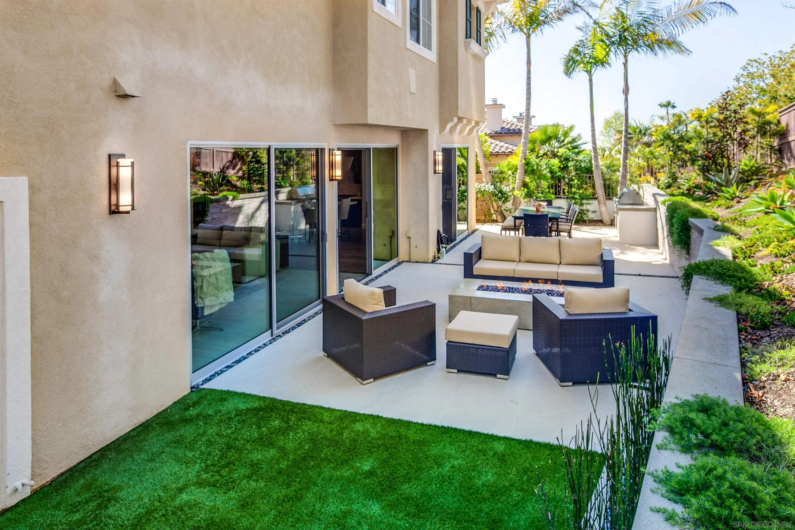1460 Ravean Court Encinitas, CA 92024 - Photo 41 of 48 a view of a patio with couches table and chairs and potted plants