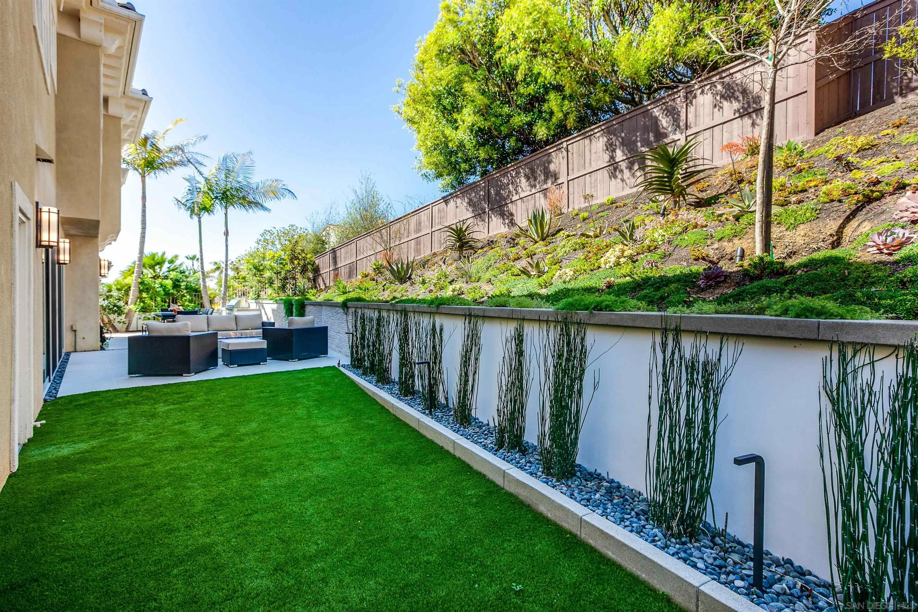 1460 Ravean Court Encinitas, CA 92024 - Photo 44 of 48 a view of a backyard with wooden fence