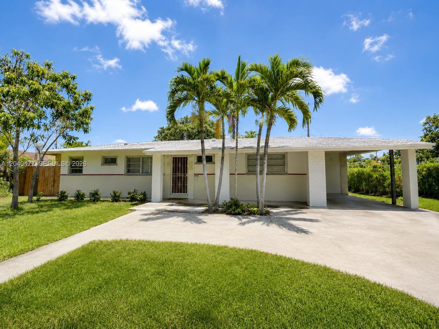 9110 Southwest 44th Street Miami, FL 33165 - Photo 1 of 18 a front view of a house with a yard and potted plants