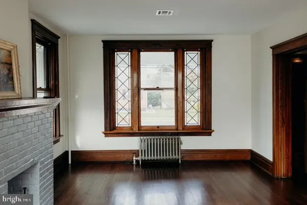 a view of front door with wooden floor and a window