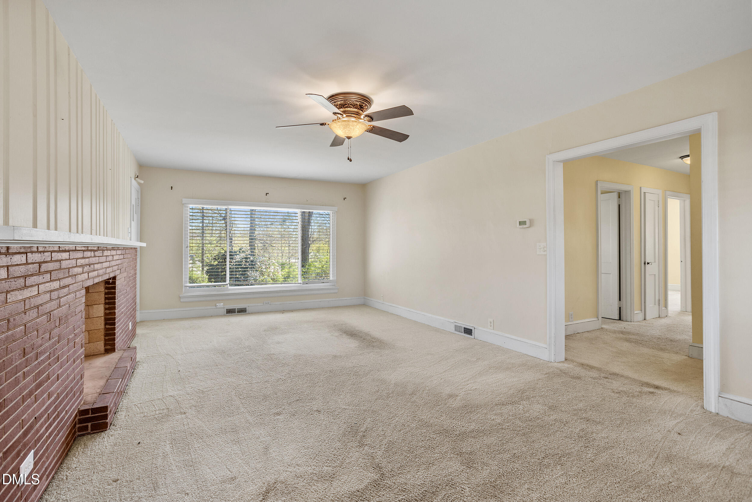 5011 Old Stage Road Raleigh, NC 27603 - Photo 10 of 29 a view of an empty room with a fireplace and a window