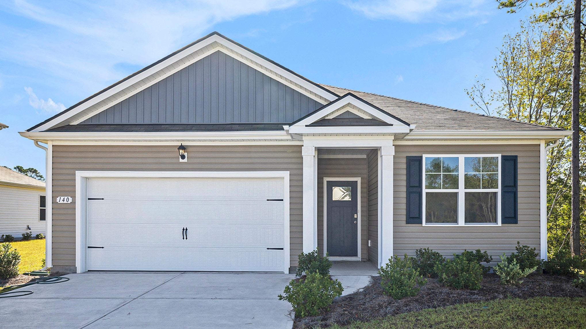 319 Skyward Street Myrtle Beach, SC 29588 - Photo 1 of 24 View of front of home with concrete driveway, board and batten siding, an attached garage, and roof with shingles