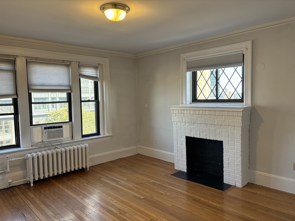 448 Park Drive, Unit 17 Boston, MA 02215 - Photo 1 of 11 a view of an empty room with wooden floor and a window