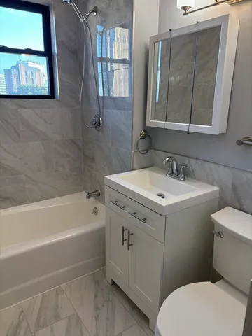 a white toilet sitting next to a bathroom sink