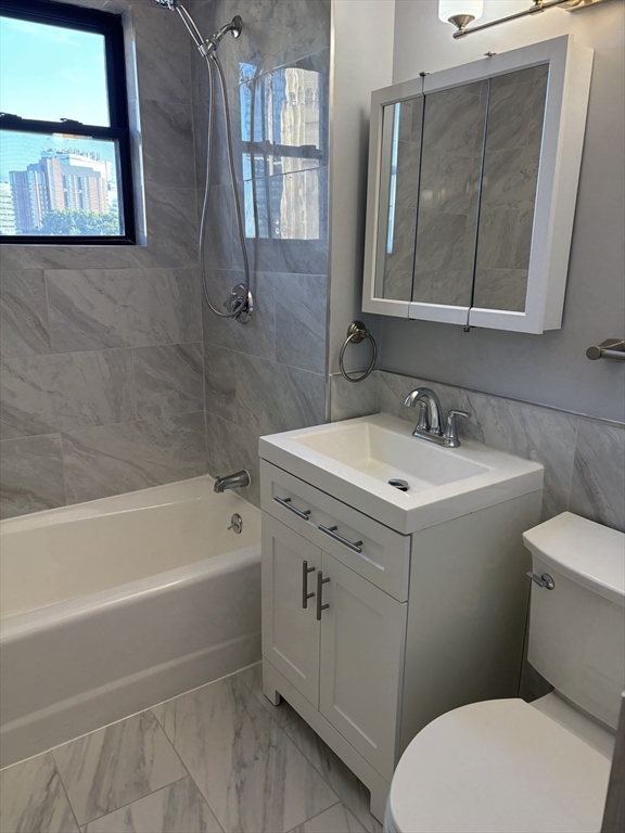 448 Park Drive, Unit 17 Boston, MA 02215 - Photo 2 of 11 a white toilet sitting next to a bathroom sink
