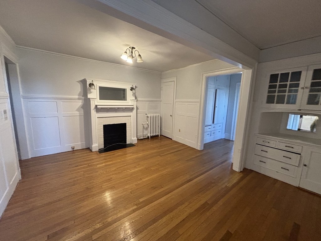448 Park Drive, Unit 17 Boston, MA 02215 - Photo 5 of 11 a view of empty room with wooden floor and fireplace