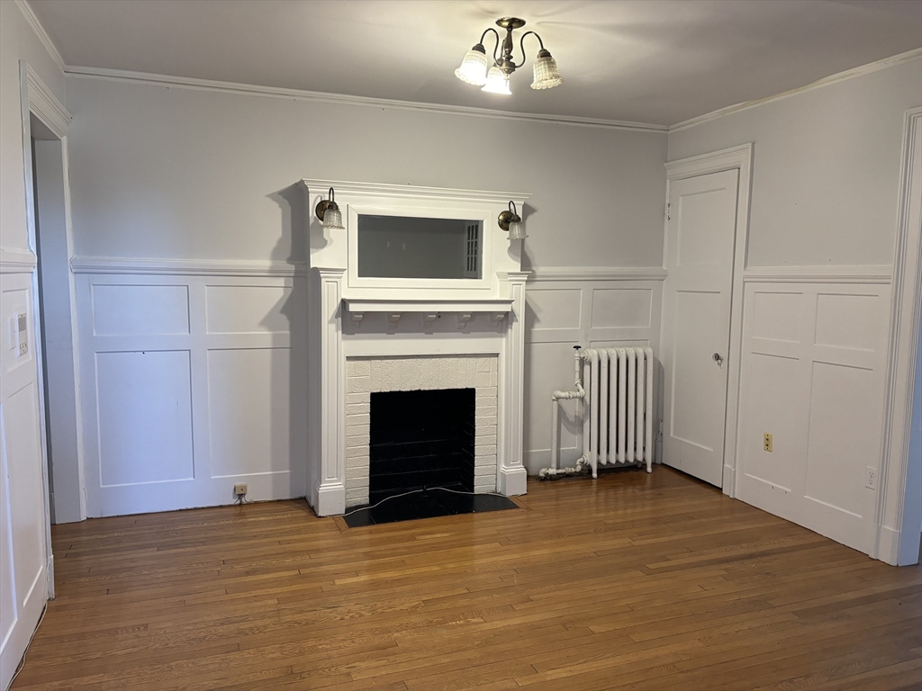 448 Park Drive, Unit 17 Boston, MA 02215 - Photo 6 of 11 a view of a livingroom with a fireplace a ceiling fan and refrigerator