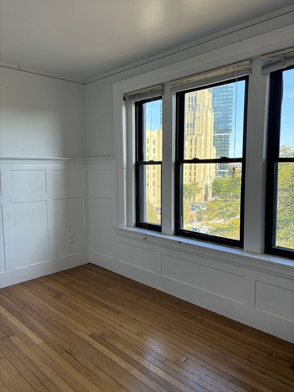 448 Park Drive, Unit 17 Boston, MA 02215 - Photo 7 of 11 a view of an empty room with wooden floor and a window