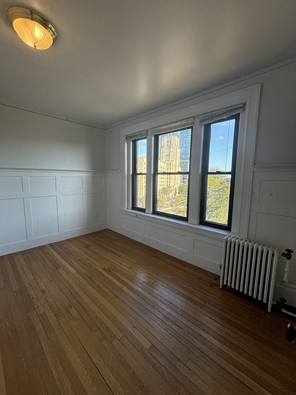 448 Park Drive, Unit 17 Boston, MA 02215 - Photo 8 of 11 an empty room with wooden floor and windows