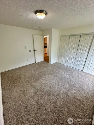 a view of a big room with wooden floor and windows