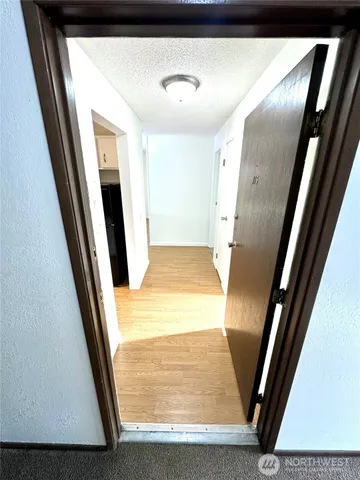 a view of a kitchen from a hallway