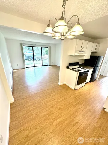a view of a living room with wooden floor