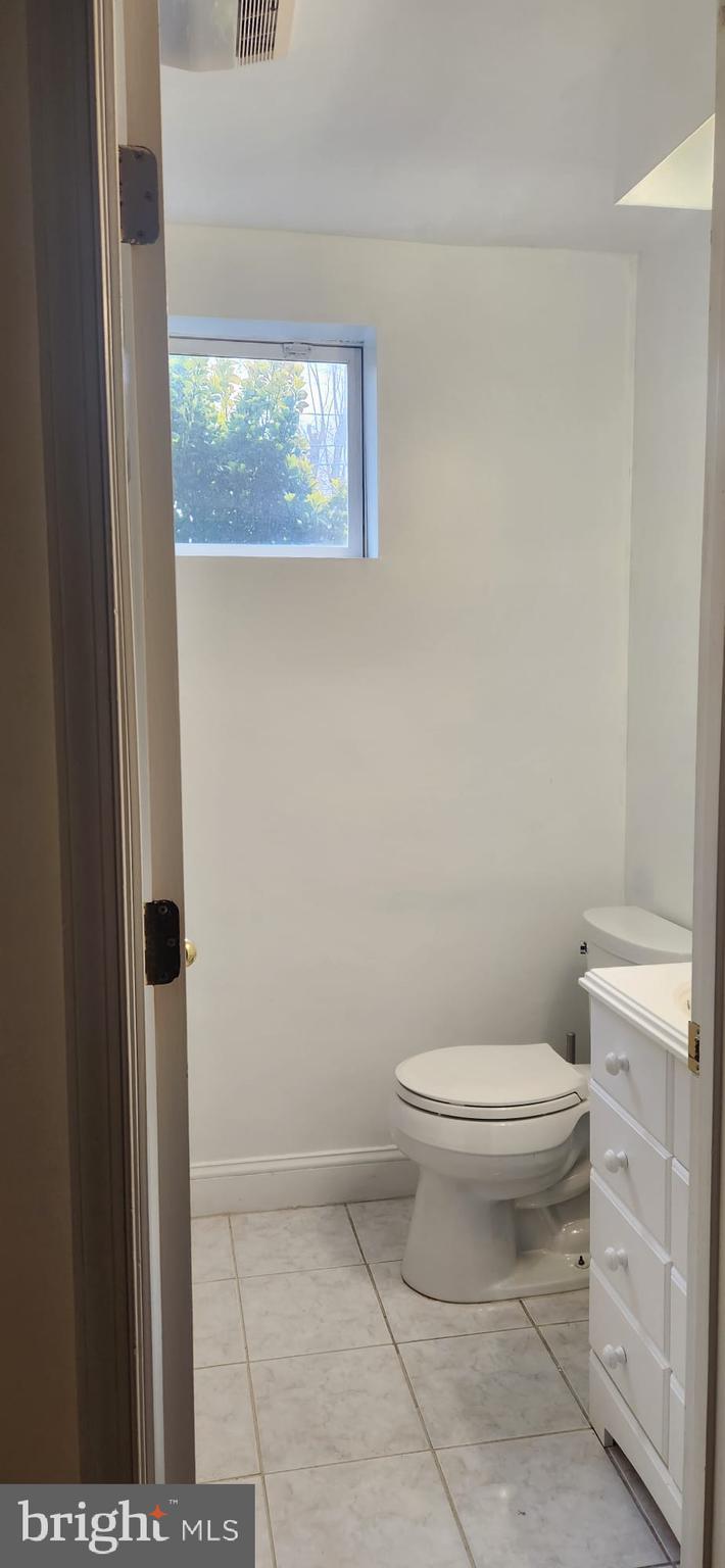 1134 12th Street Laurel, MD 20707 - Photo 11 of 13 a white toilet sitting next to a shower