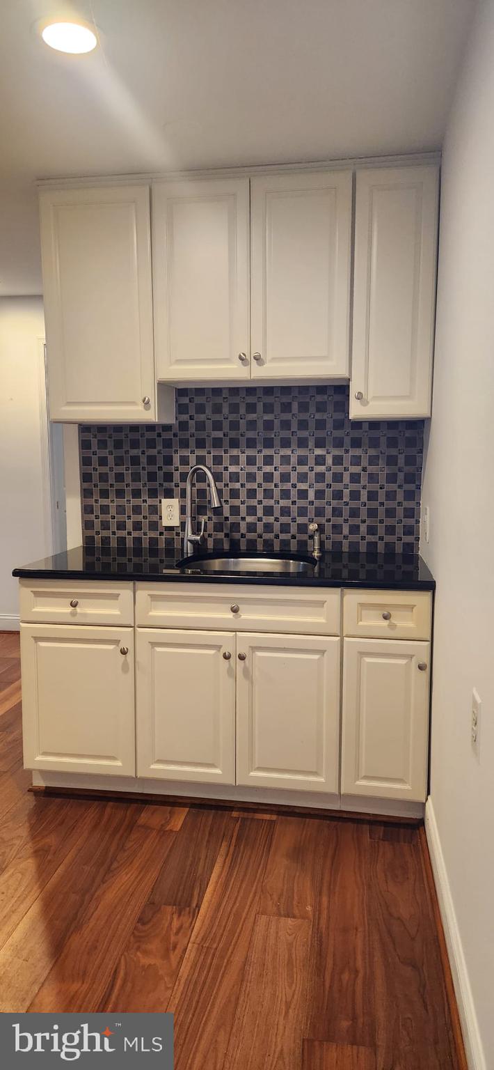 1134 12th Street Laurel, MD 20707 - Photo 13 of 13 a kitchen with granite countertop white cabinets and white appliances