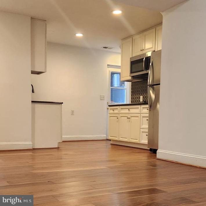 1134 12th Street Laurel, MD 20707 - Photo 2 of 13 a kitchen with stainless steel appliances a refrigerator and a stove top oven