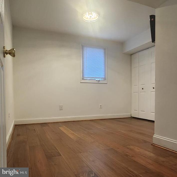 1134 12th Street Laurel, MD 20707 - Photo 3 of 13 an empty room with wooden floor and windows