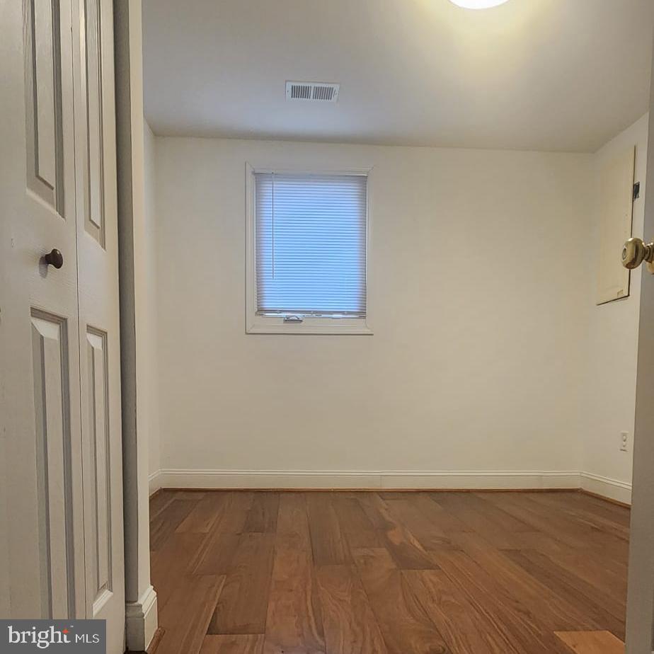 1134 12th Street Laurel, MD 20707 - Photo 5 of 13 an empty room with wooden floor and windows