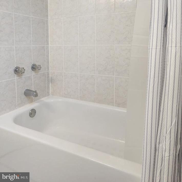 1134 12th Street Laurel, MD 20707 - Photo 7 of 13 a bathroom with a bathtub
