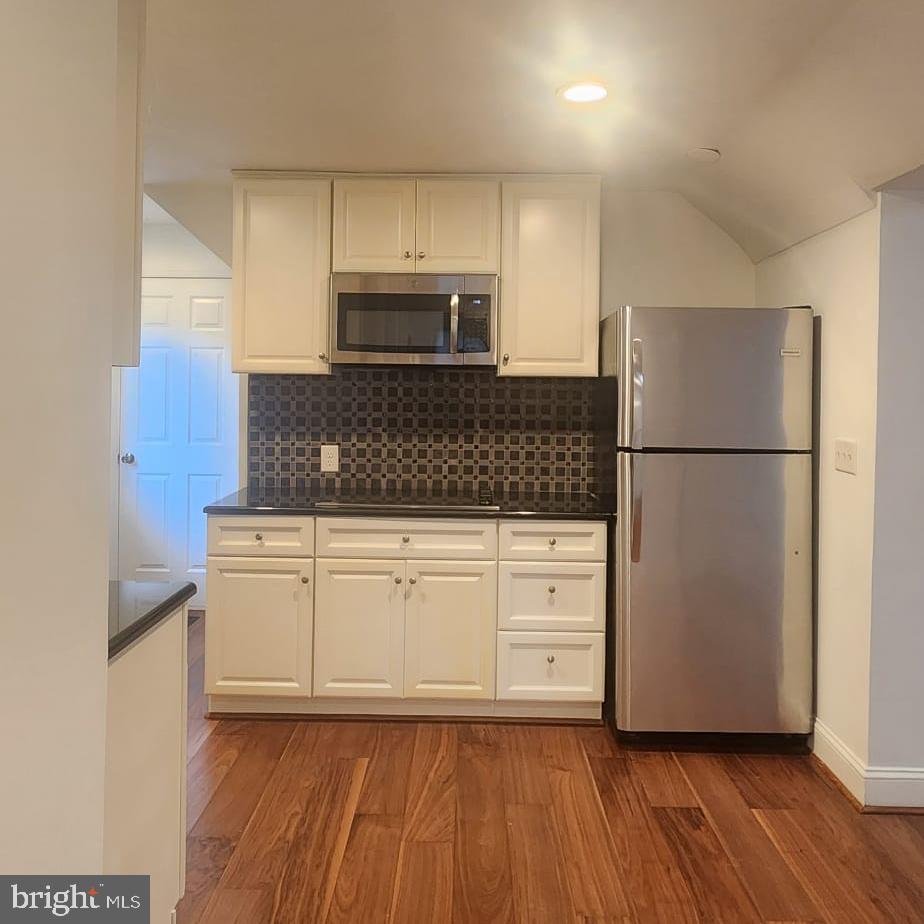 1134 12th Street Laurel, MD 20707 - Photo 10 of 13 a kitchen with stainless steel appliances granite countertop a refrigerator microwave and cabinets