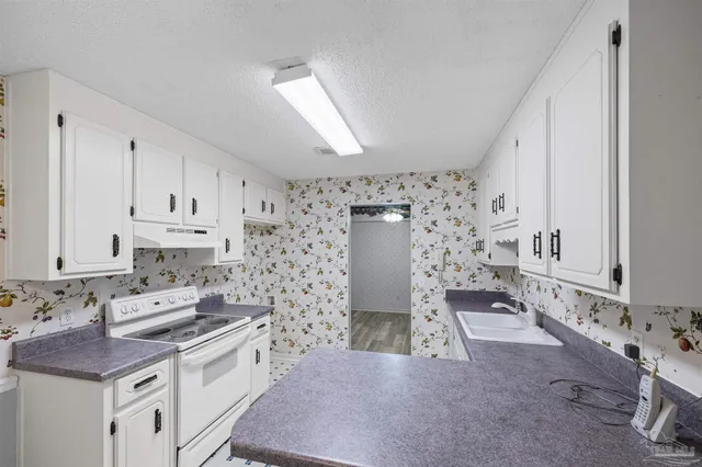 a kitchen with stainless steel appliances a stove a sink and a refrigerator