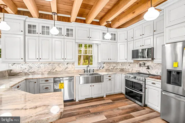 a view of a livingroom with wooden floor and a fireplace