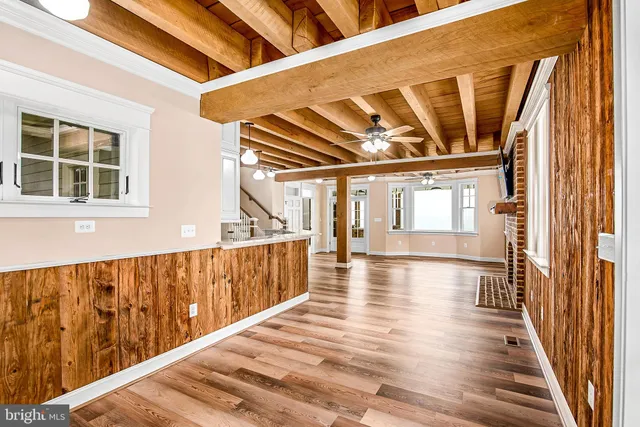 a view of a house with a barbeque and wooden floor