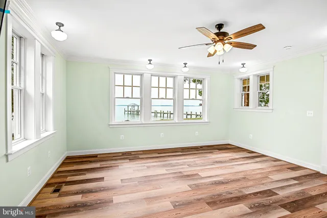 a view of a dining room with furniture a chandelier and wooden floor