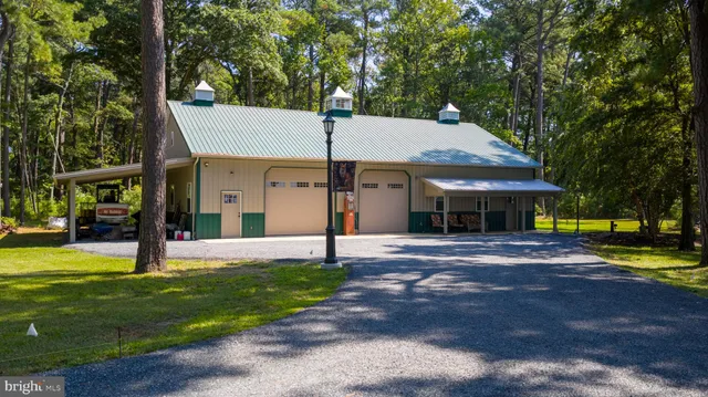 a view of a livingroom with furniture wooden floor and windows