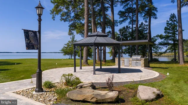 a view of a house with swimming pool and sitting area