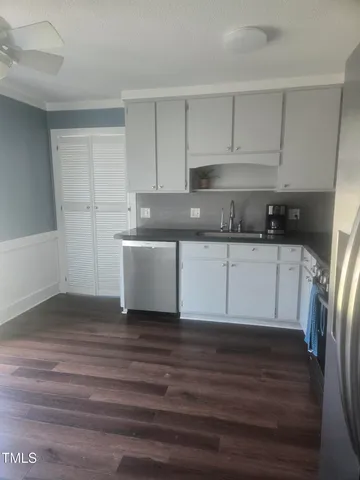 a kitchen with wooden cabinets and a sink