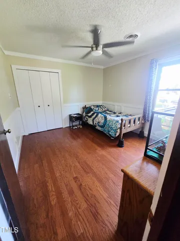 a bed room with a bed and a window