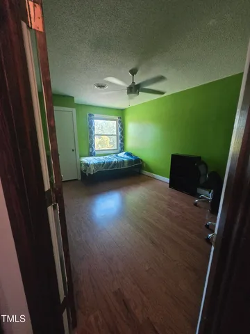 wooden floor in a hall with a window