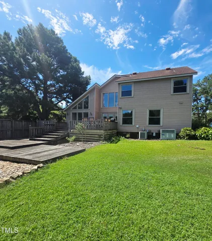 a view of a house with backyard and sitting area