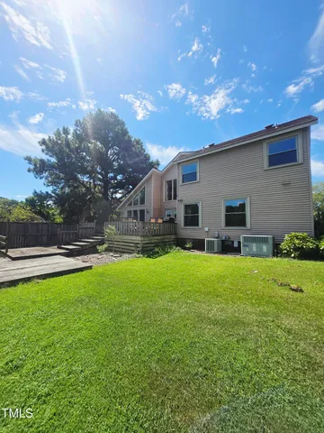 a view of a yard with a house and a large tree