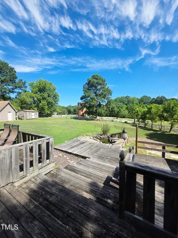 a view of a deck with a big yard