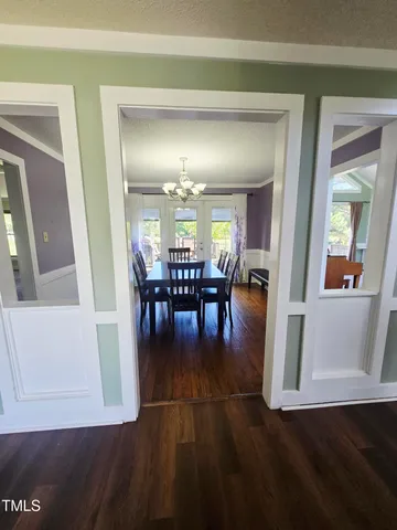 a view of a dining room with furniture and wooden floor