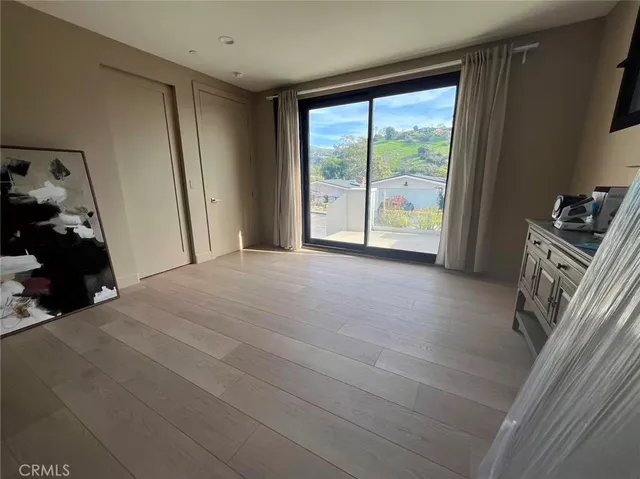 a bed room with a bed and a large window