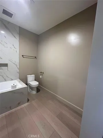 a bathroom with a sink a toilet and mirror