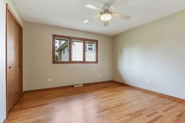 13000 Winnebago Road Palos Heights, IL 60463 - Photo 12 of 15 a view of an empty room with wooden floor and a window