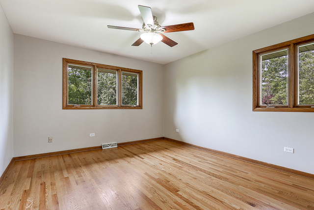 13000 Winnebago Road Palos Heights, IL 60463 - Photo 13 of 15 a view of an empty room with wooden floor and a window