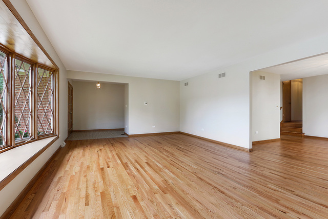 13000 Winnebago Road Palos Heights, IL 60463 - Photo 4 of 15 a view of an empty room and window with wooden floor in a room