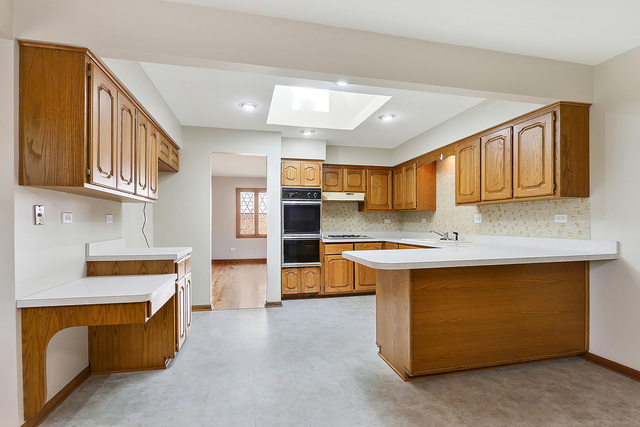 13000 Winnebago Road Palos Heights, IL 60463 - Photo 6 of 15 a kitchen with stainless steel appliances granite countertop a stove and a sink