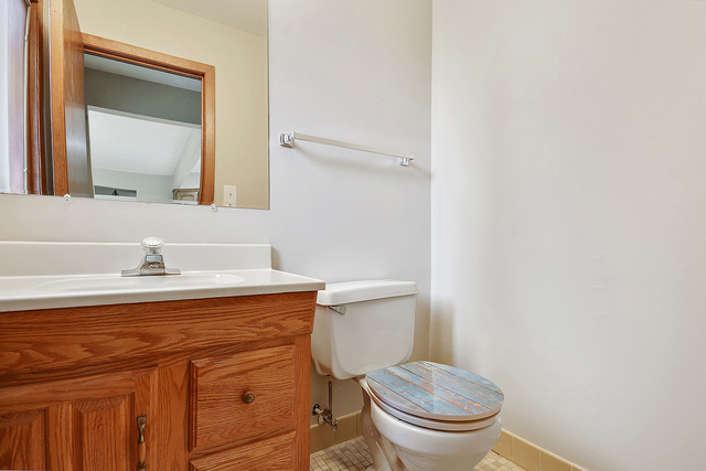 13000 Winnebago Road Palos Heights, IL 60463 - Photo 9 of 15 a bathroom with a granite countertop toilet sink and mirror