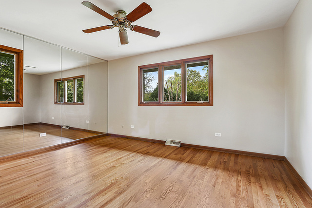 13000 Winnebago Road Palos Heights, IL 60463 - Photo 10 of 15 a view of empty room with wooden floor and fan