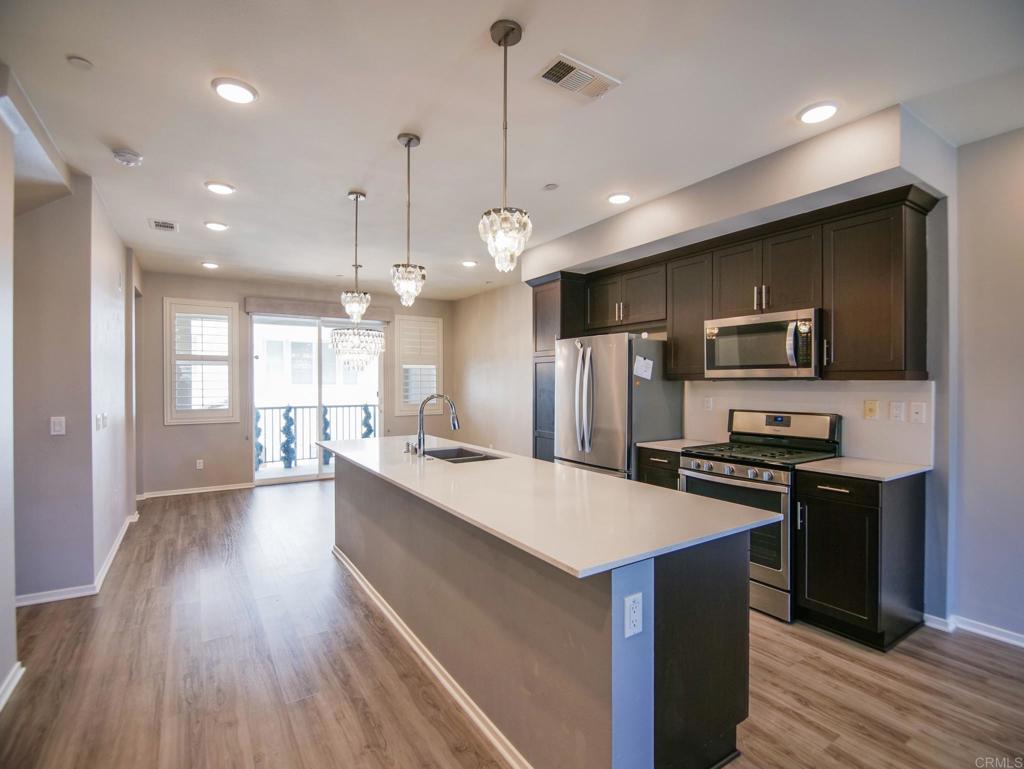 a large kitchen with stainless steel appliances kitchen island a large island in the center