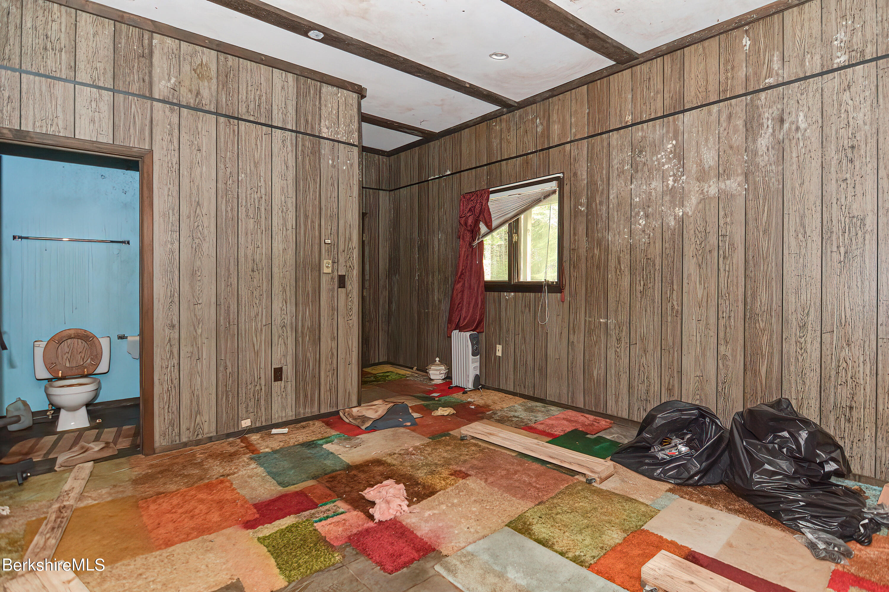72 Jackson Road Savoy, MA 01256 - Photo 26 of 42 a bedroom with a bed and a chandelier
