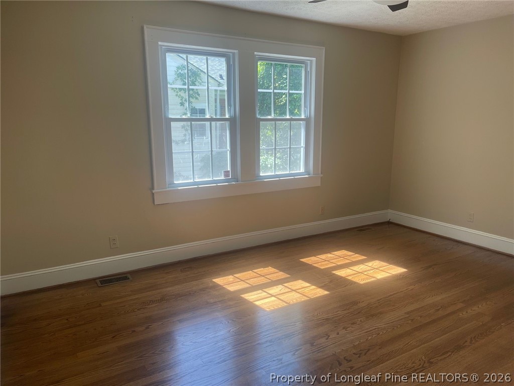 2515 Fort Bragg Road Fayetteville, NC 28303 - Photo 17 of 23 an empty room with wooden floor and windows